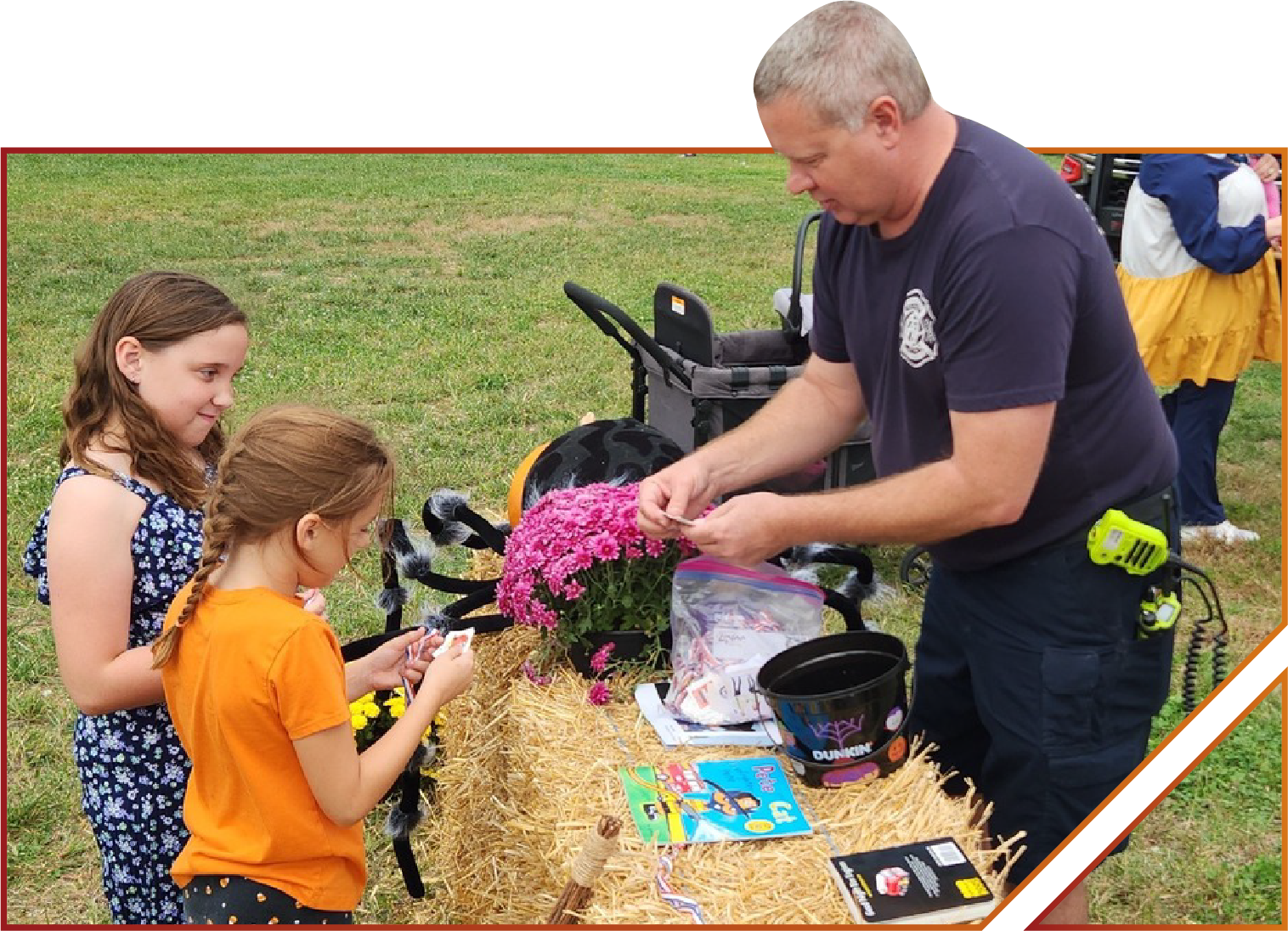 A irefighter hands out treats and fire safety info at the Auffenberg trunk or treat